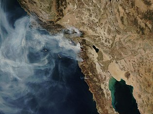 Satellitfoto från NASA (24 oktober) som visar de pågående bränderna och dessas rökplymer.